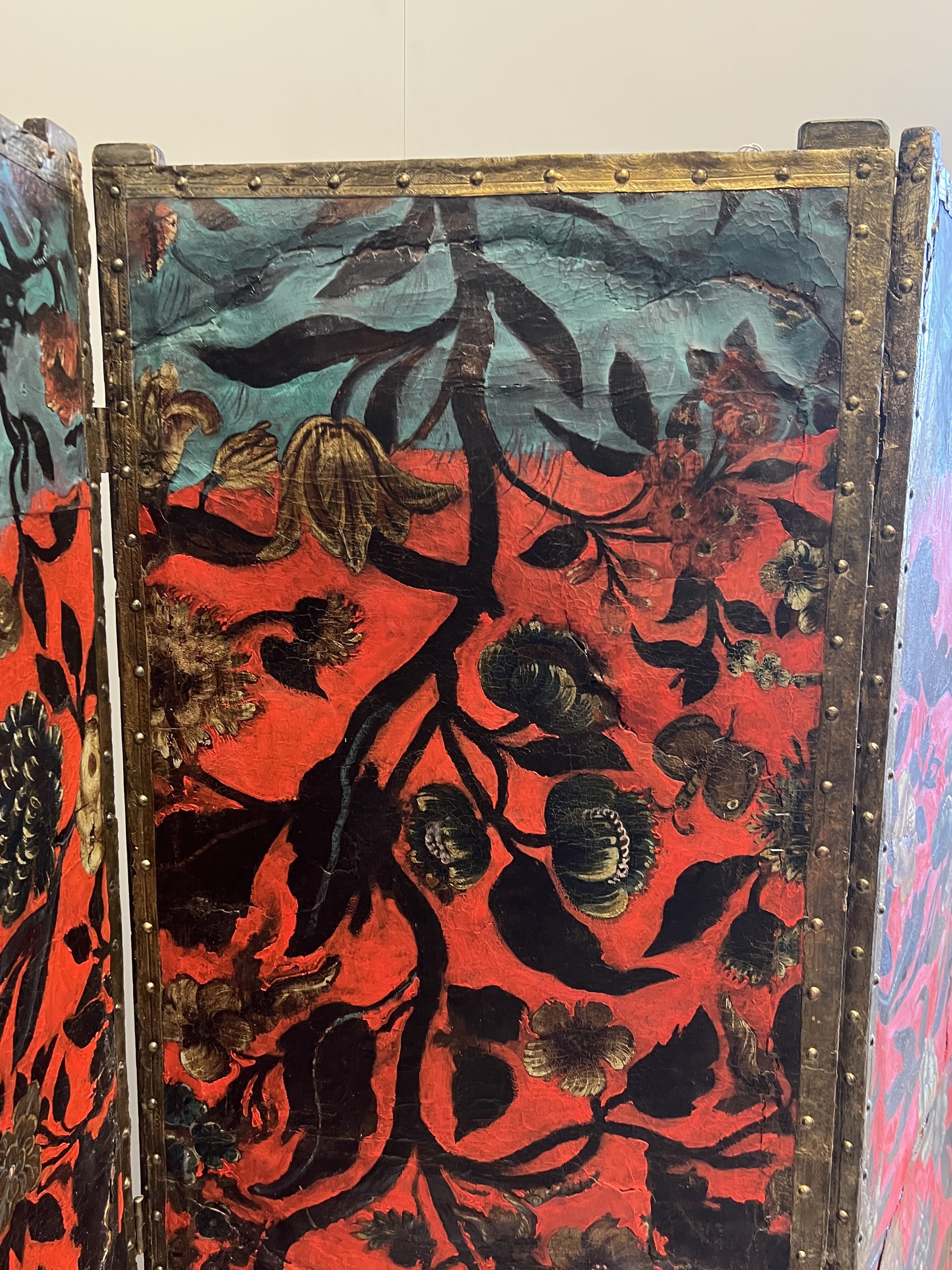 A 19th century Spanish leather three fold dressing screen re-painted by Ricardo Cinalli for the current owner, each panel width 57cm, height 175cm